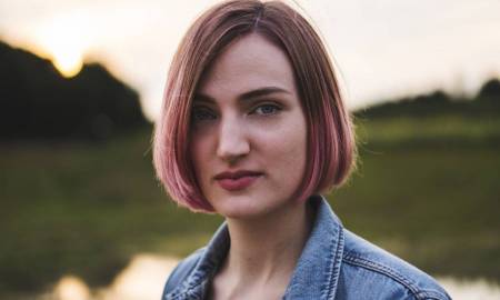 teen-daughter-with-pink-hair-looking-into-the-camera