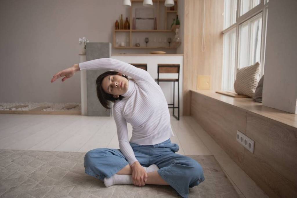 A woman doing a relaxing yoga pose at home